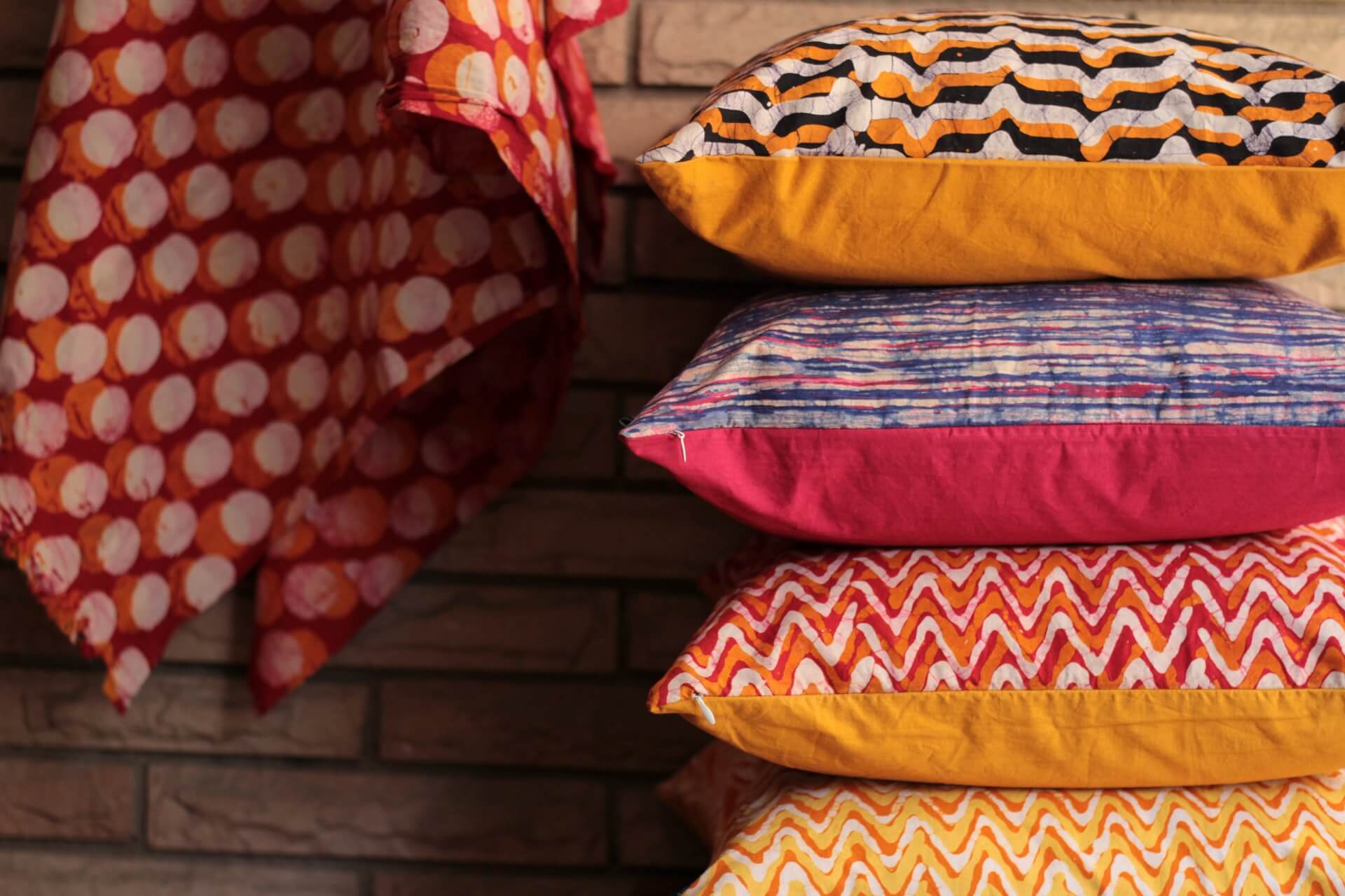 colorful pillows with various patterns stacked